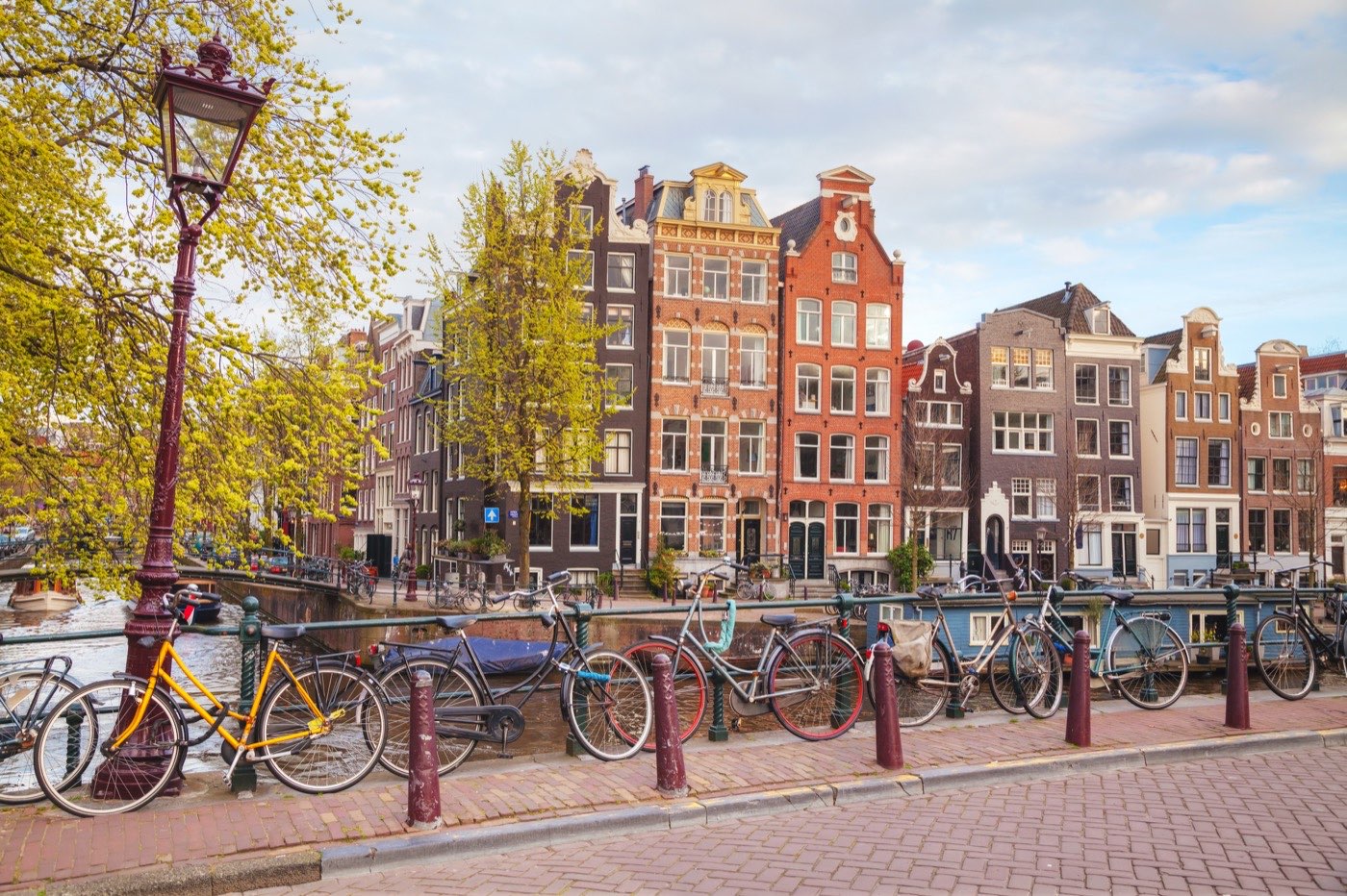 An Amsterdam canal in spring, bicycles lining the bridge