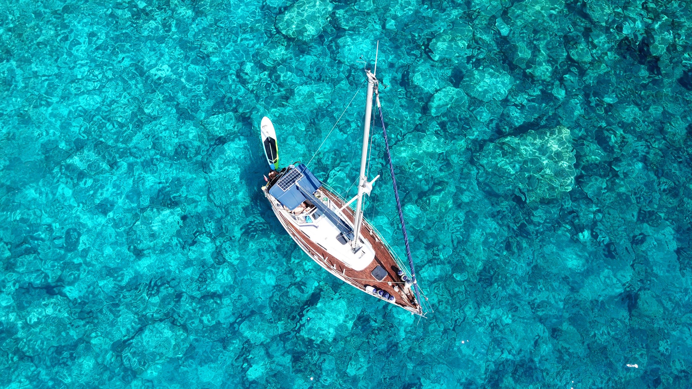 A yacht at anchor over reef, Caribbean
