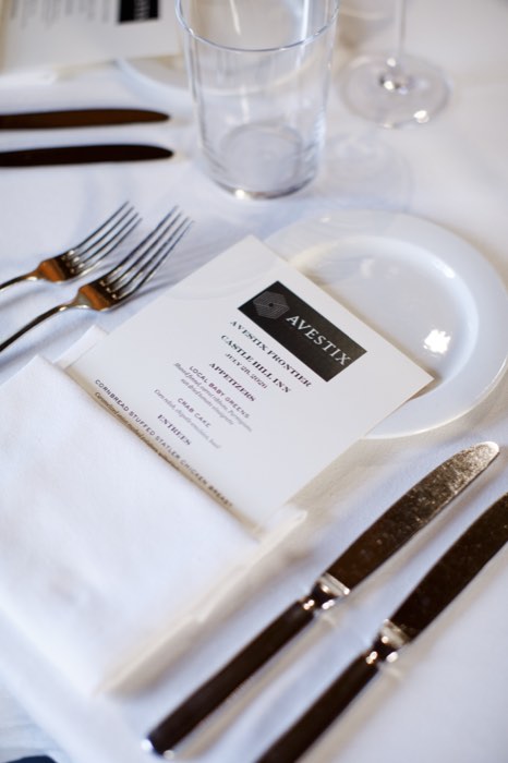 A place setting laid for the evening, the Avestix menu card at each seat.