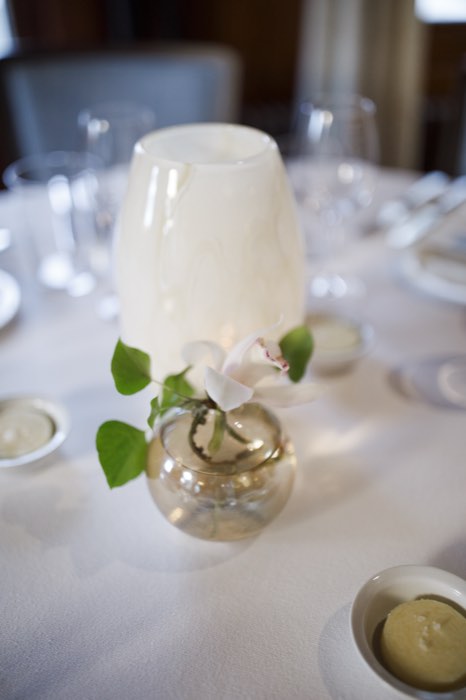 Candlelight and a single white orchid at the centre of each table.
