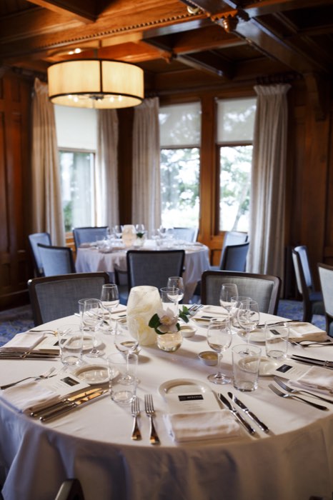 The dining room at Castle Hill Inn, tables set against the window light.