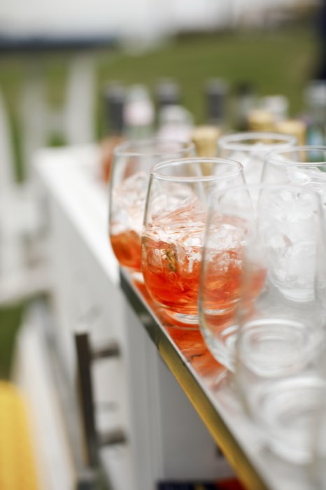 Cocktails lined up along the bar.