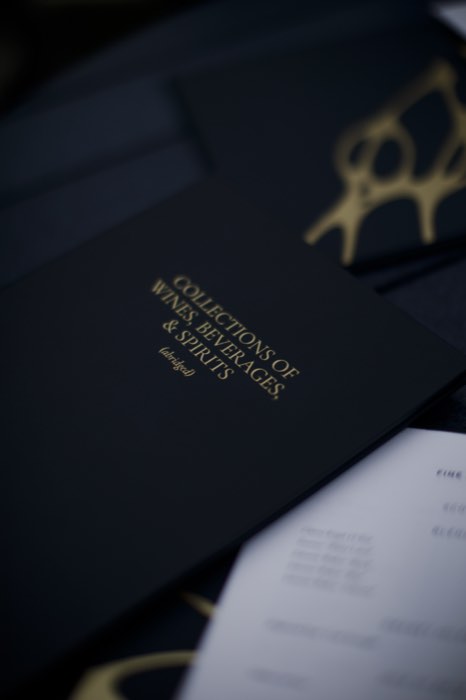 Gold on navy: the evening's folder.
