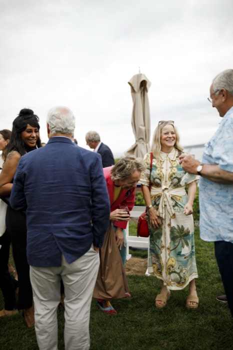 Guests beneath the lawn umbrellas.