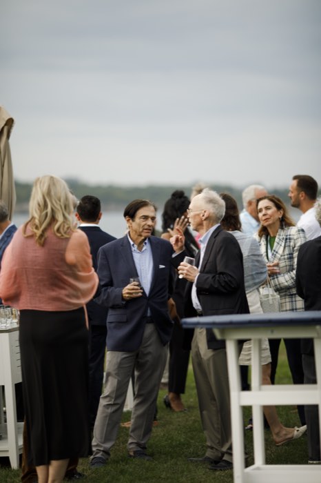 The reception, spread between the standing tables.