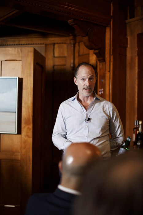 R. Adam Smith, sharing insights with the room.