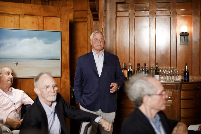 Mid-remarks, the room attentive.