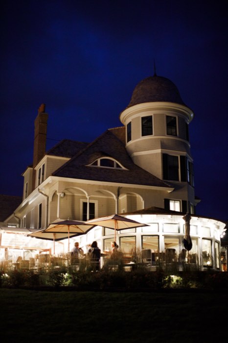 Castle Hill Inn at blue hour, the terrace lit below the turret.