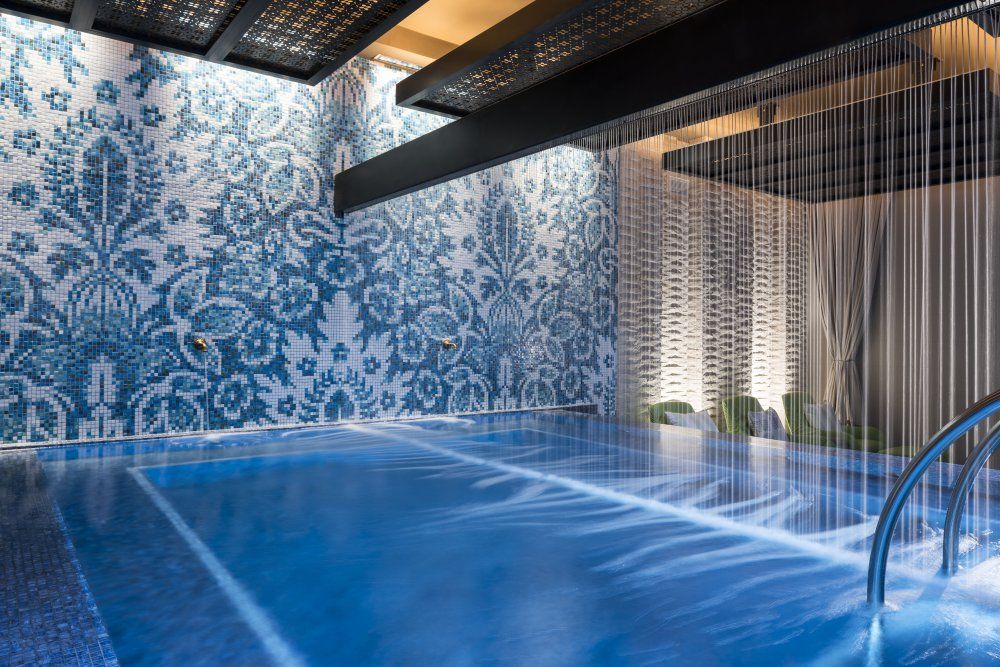 The spa pool at Seafire, with a water curtain falling past a patterned blue tile wall