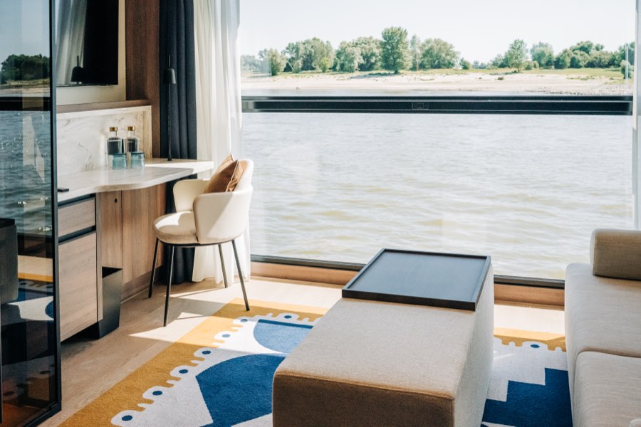 A suite sitting area with river-view windows